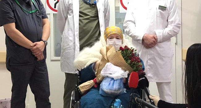 Pelageya Poyarkova, 100, wearing a protective mask poses for a picture as she leaves the Brain Centre in Moscow on May 13, 2020. Handout / AFP