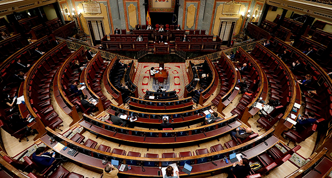 Spanish Prime Minister Pedro Sanchez (C) delivers a speech during a session to debate the extension of a national lockdown to curb the spread of the novel coronavirus at the Lower Chamber of the Spanish parliament in Madrid on May 6, 2020. J. J. GUILLEN / POOL / AFP