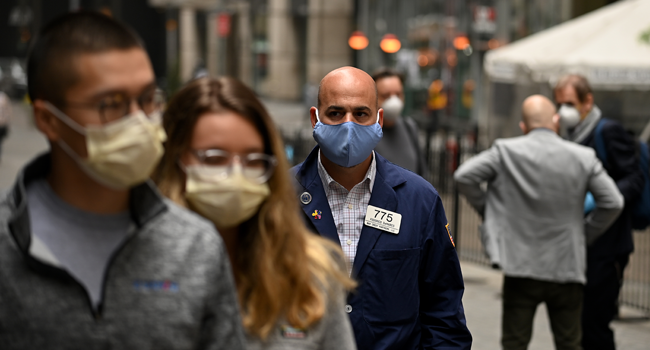 A trader walks in front of the New York Stock Exchange (NYSE) on May 26, 2020 at Wall Street in New York City. Johannes EISELE / AFP