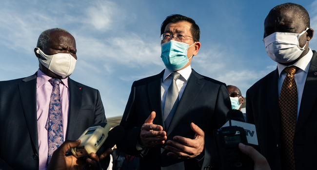 Zimbabwe Minister of Local Government and Social Welfare July Moyo (L) with the Chinese ambassador Guo Shaochun (C) as they speak to the press on May 11, 2020 during the welcome ceremony held fora team of health experts from China that will help with the fight against the COVID-19 coronavirus at the Robert Mugabe International Airport in Harare. Jekesai NJIKIZANA / AFP