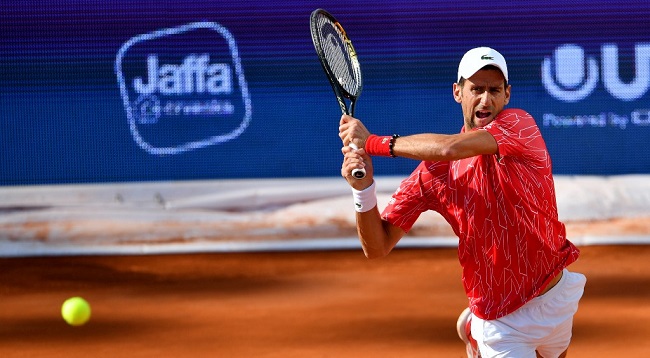 Serbian tennis player Novak Djokovic returns the ball to Serbian tennis player Viktor Troicki during their single match at a charity exhibition hosted by Novak Djokovic, on June 13, 2020 in Belgrade. - The ATP and WTA Tours have been suspended since March due to the COVID-19 pandemic and will not resume at least until the end of July 2020. (Photo by Andrej ISAKOVIC / AFP)