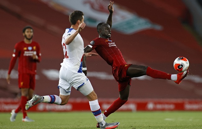 Crystal Palace's English defender Joel Ward (L) vies with Liverpool's Senegalese striker Sadio Mane during the English Premier League football match between Liverpool and Crystal Palace at Anfield in Liverpool, north west England on June 24, 2020. (Photo by PHIL NOBLE / POOL / AFP)
