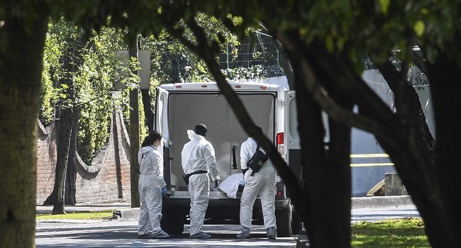 Forensic experts remove a corpse from the crime scene after Mexico City's Public Security Secretary Omar Garcia Harfuch attacked in Mexico City, on June 26, 2020. - Mexico City's security chief was wounded in a gun attack Friday in which two of his bodyguards and a woman passerby were killed, Mayor Claudia Sheinbaum said. (Photo by PEDRO PARDO / AFP)