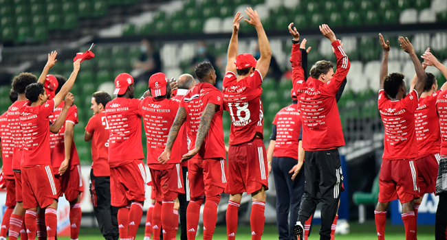 Bayern's players celebrate after the German first division Bundesliga football match SV Werder Bremen v FC Bayern Munich on June 16, 2020 in Bremen, northern Germany. Martin MEISSNER / POOL / AFP