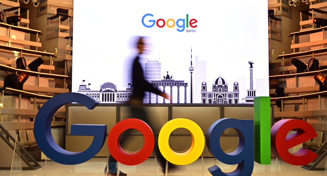  In this file photo taken on January 22, 2019 a technician passes by a logo of US internet search giant Google during the opening day of a new Berlin office of Google in Berlin. Tobias SCHWARZ / AFP