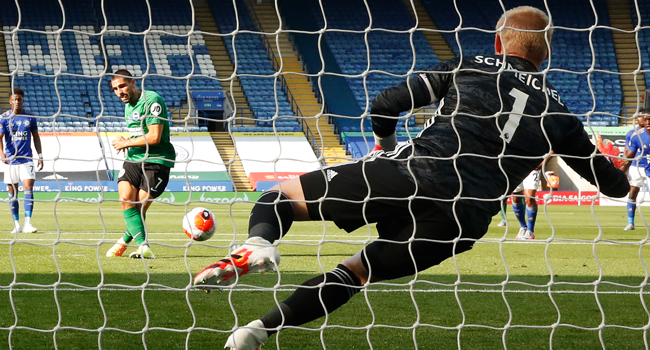 Leicester City's Danish goalkeeper Kasper Schmeichel (R) jumps and saves a penalty hit by Brighton's French striker Neal Maupay (L) during the English Premier League football match between Leicester City and Brighton and Hove Albion at the King Power Stadium in Leicester, central England, on June 23, 2020. ANDREW BOYERS / POOL / AFP