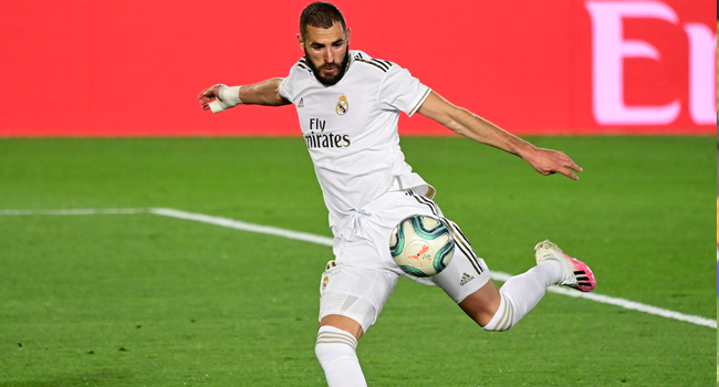 Real Madrid's French forward Karim Benzema eyes on the ball prior to shooting and scoring his second goal during the Spanish league football match between Real Madrid CF and Valencia CF at the Alfredo di Stefano stadium in Valdebebas, on the outskirts of Madrid, on June 18, 2020. JAVIER SORIANO / AFP