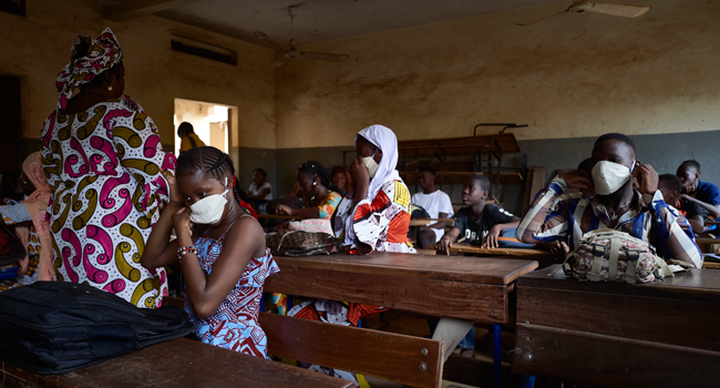 Malian pupils wear face masks in the classroom of a school as the government decided to resume lessons after two months of closure due to the spread of COVID-19 coronavirus, in Bamako on June 2, 2020. MICHELE CATTANI / AFP