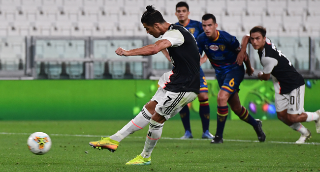 Juventus' Portuguese forward Cristiano Ronaldo shoots to score a penalty during the Italian Serie A football match Juventus vs Lecce played on June 26, 2020 behind closed doors at the Juventus stadium in Turin, as the country eases its lockdown aimed at curbing the spread of the COVID-19 infection, caused by the novel coronavirus. Miguel MEDINA / AFP