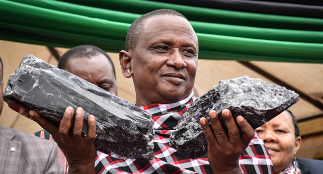 Tanzanian small-scale miner Saniniu Kuryan Laizer, 52, poses with two of the biggest of the country's precious gemstones, Tanzanite, as a millionaire during the ceremony for his historical discovery in Manyara, northern Tanzania, on June 24, 2020. Filbert RWEYEMAMU / AFP