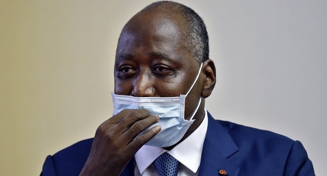 Ivory Coast Prime Minister and ruling party's candidate in the October 2020 presidential election Amadou Gon Coulibaly, wearing a protective face mask, delivers a speech to members of the government upon his arrival at Felix Houphouet Boigny Airport after "recovering" in France following heart problems in Abdijan on July 2, 2020. (Photo by SIA KAMBOU / AFP)