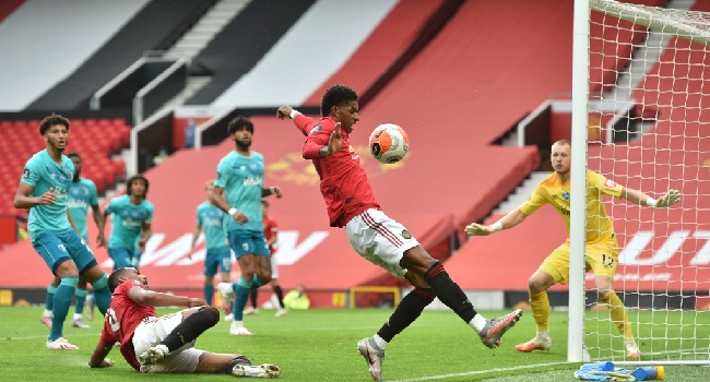 Manchester United's English striker Marcus Rashford (C) controls the ball during the English Premier League football match between Manchester United and Bournemouth at Old Trafford in Manchester, north west England, on July 4, 2020. (Photo by PETER POWELL / POOL / AFP) /