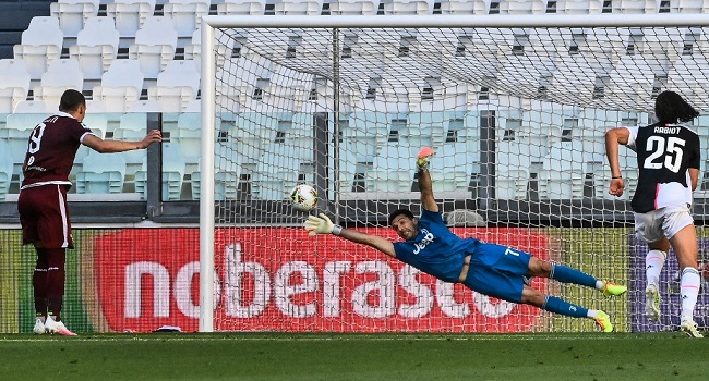 Torino's Italian forward Andrea Belotti (L) scores a penalty past Juventus' Italian goalkeeper Gianluigi Buffon during the Italian Serie A football match Juventus vs Torino played behind closed doors on July 4, 2020 at the Juventus stadium in Turin, as the country eases its lockdown aimed at curbing the spread of the COVID-19 infection, caused by the novel coronavirus. (Photo by Marco BERTORELLO / AFP)