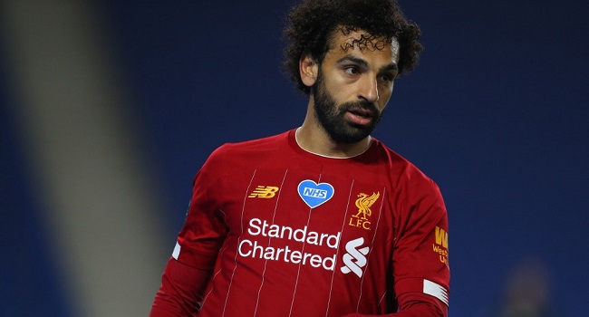 A NHS badge is dislayed on the shirt of Liverpool's Egyptian midfielder Mohamed Salah during the English Premier League football match between Brighton and Hove Albion and Liverpool at the American Express Community Stadium in Brighton, southern England on July 8, 2020. (Photo by Catherine Ivill / POOL / AFP)