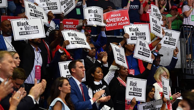 (FILES) In this file photo taken on June 20, 2020 Governor Kevin Stitt claps among "Black Voices for Trump" supporters as US President Donald Trump speaks during a campaign rally at the BOK Center on June 20, 2020 in Tulsa, Oklahoma. (Photo by Nicholas Kamm / AFP)