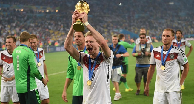 Germany forward Andre Schuerrle holds up the World Cup trophy in Rio de Janeiro after Germany won the final of Brazil 2014. (AFP Photo/PATRIK STOLLARZ)