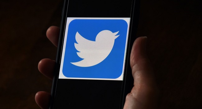 (FILES) In this file photo illustration, a Twitter logo is displayed on a mobile phone on May 27, 2020, in Arlington, Virginia. - Twitter shares closed the formal trading day up more than 7 percent after word spread of a team codenamed "Gryphon" working on a subscription platform. (Photo by Olivier DOULIERY / AFP)