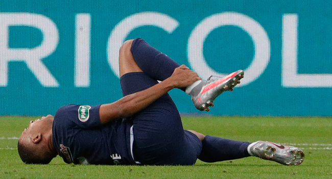 In this file photo taken on July 24, 2020 Paris Saint-Germain's French forward Kylian Mbappe reacts after an injury during the French Cup final football match between Paris Saint-Germain (PSG) and Saint-Etienne (ASSE), at the Stade de France in Saint-Denis, outside Paris. GEOFFROY VAN DER HASSELT / AFP