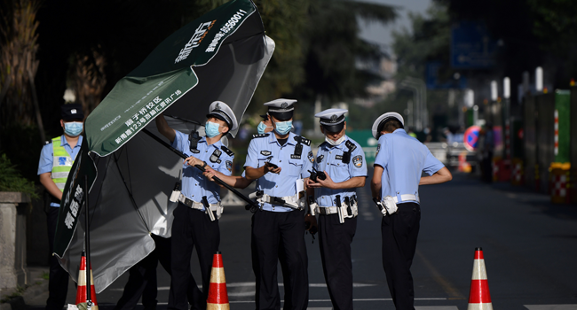 Policemen stand guard on a road leading to the US Consulate in Chengdu, southwestern China's Sichuan province on July 27, 2020. Noel Celis / AFP