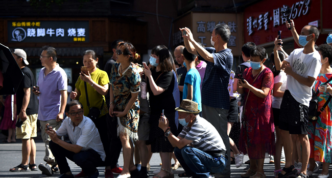 People stand on a road leading to the US Consulate in Chengdu, southwestern China's Sichuan province on July 27, 2020. Noel Celis / AFP