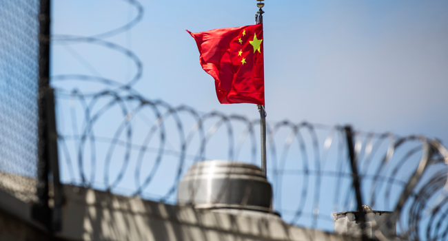 In this file photo taken on July 23, 2020, the Chinese flag flies behind barbed wire at the Chinese Consulate General in San Francisco. Philip Pacheco / AFP