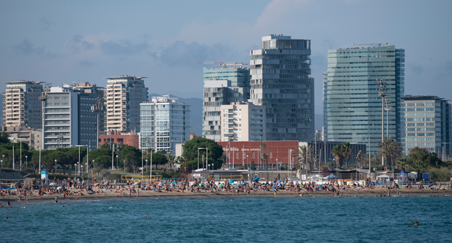 People enjoy a day at El Bogatell Beach in Barcelona on July 1, 2020. Josep LAGO / AFP