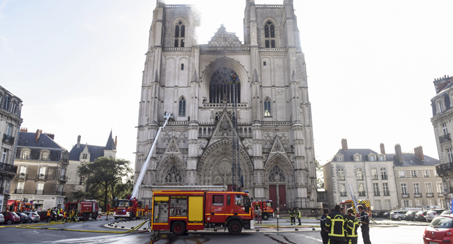 Firefighters are at work to put out a fire at the Saint-Pierre-et-Saint-Paul cathedral in Nantes, western France, on July 18, 2020.  Sebastien SALOM-GOMIS / AFP