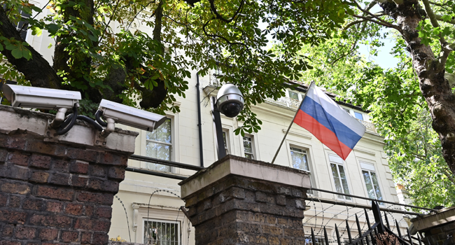 A Russian flag flies by surveillance cameras at the entrance to the Russian consulate in London on July 21, 2020. JUSTIN TALLIS / AFP