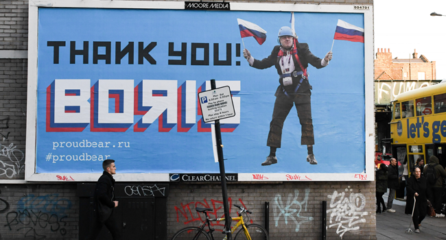  In this file photo taken on November 08, 2018 A Brexit-themed billboard depicting Britain's former foreign secretary Boris Johnson waving Russian national flags reading "Thank you Boris" is seen in east London on November 8, 2018. Daniel SORABJI / AFP