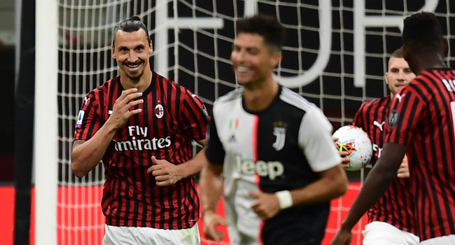 AC Milan's Swedish forward Zlatan Ibrahimovic (L) reacts next to Juventus' Portuguese forward Cristiano Ronaldo (C) after scoring a penalty during the Italian Serie A football match AC Milan vs Juventus played behind closed doors on July 7, 2020 at the San Siro stadium in Milan, as the country eases its lockdown aimed at curbing the spread of the COVID-19 infection, caused by the novel coronavirus. Miguel MEDINA / AFP