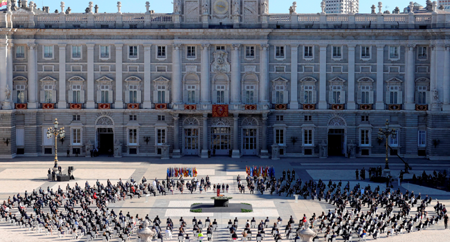 Attendees sit around a cauldron during a state ceremony to honour the 28,400 victims of the coronavirus crisis as well as those public servants who have been fighting on the front line against the pandemic in Spain, on July 16, 2020, at the Royal Palace in Madrid. Juanjo Martin / POOL / AFP