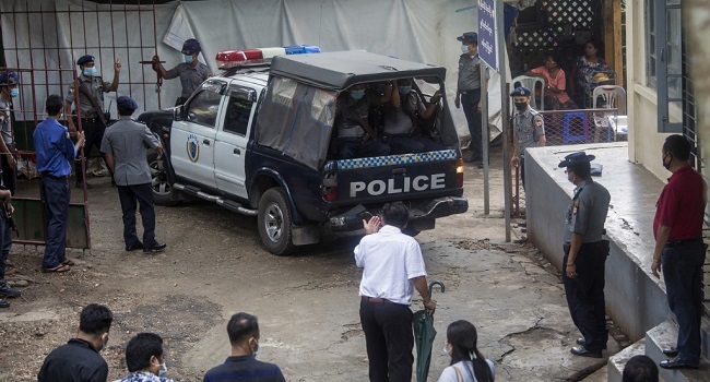 A police vehicle carrying Canadian pastor David Lah arrives at a township court for a hearing in Yangon on August 6
