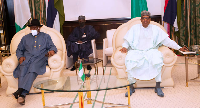 A photo taken on August 26, 2020, shows former President Goodluck Jonathan with President Muhammadu Buhari at the Presidential Villa in Abuja