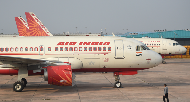 In this file photo taken on March 2, 2020 Air India planes are seen parked at the Indira Gandhi International airport, in New Delhi. Money SHARMA / AFP