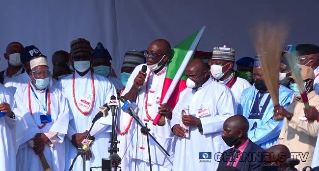 APC candidate for the Edo Governorship Election, Pastor Osagie Ize-Iyamu, holds the party's flag during his campaign flag-off in Benin-city on August 4, 2020.