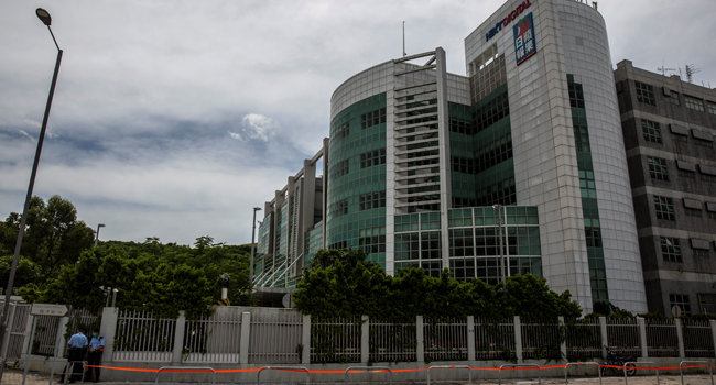 Police cordon off the street outside the Next Media publishing offices as authorities conduct a search of the premises after the company's founder Jimmy Lai was arrested under the new national security law in Hong kong on August 10, 2020. ISAAC LAWRENCE / AFP