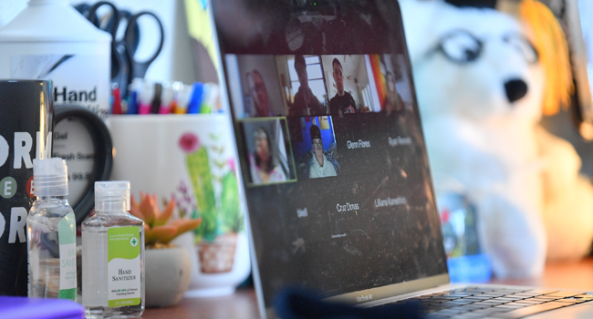 Bottles of hand sanitizer sit next to a laptop showing a Zoom meeting as students begin classes amid the coronavirus (COVID-19) pandemic on the first day of the fall 2020 semester at the University of New Mexico on August 17, 2020 in Albuquerque, New Mexico. Sam Wasson/Getty Images/AFP