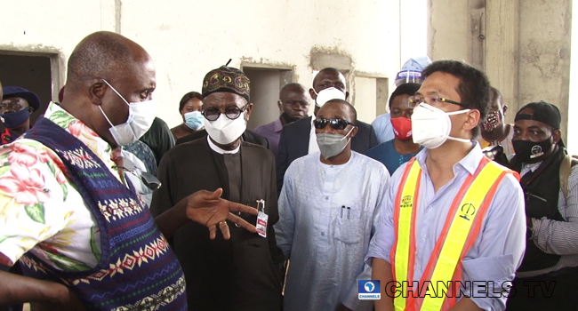 Minister of Transportation, Rotimi Amaechi speaks to a Chinese construction official during an inspection tour of the Lagos-Ibadan railway project on August 15, 2020.