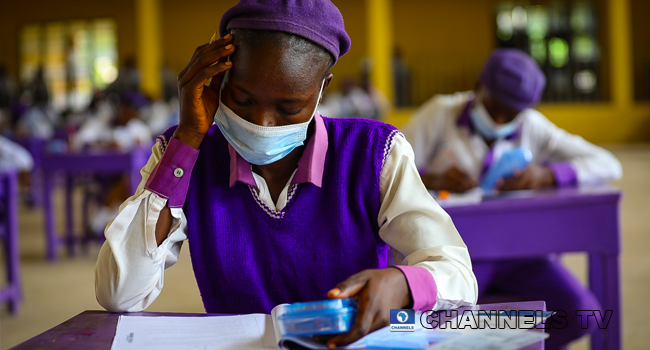 Wearing face-masks, final year students of Government Secondary School, Zone 3, Abuja, sit in a classroom as they write their West African Examinations Council exams, following the ease of COVID-19 lockdown order on Monday August 17, 2020. Photo: Sodiq Adelakun/Channels Television.