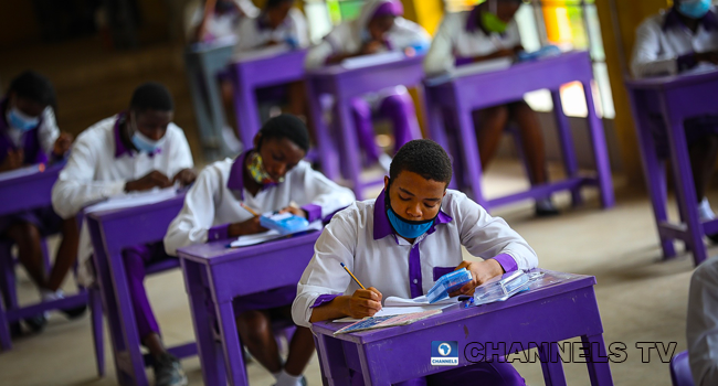 Wearing face-masks, final year students of Government Secondary School, Zone 3, Abuja, sit in a classroom as they write their West African Examinations Council exams, following the ease of COVID-19 lockdown order on Monday August 17, 2020. Photo: Sodiq Adelakun/Channels Television.