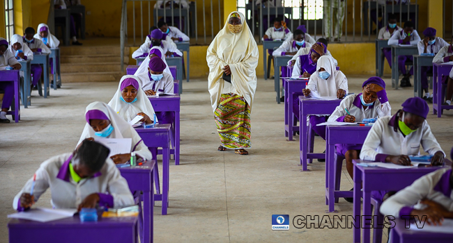 Wearing face-masks, final year students of Government Secondary School, Zone 3, Abuja, sit in a classroom as they write their West African Examinations Council exams, following the ease of COVID-19 lockdown order on Monday August 17, 2020. Photo: Sodiq Adelakun/Channels Television.
