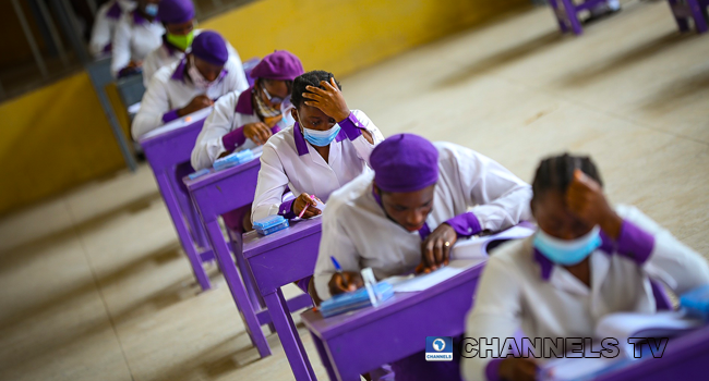 Wearing face-masks, final year students of Government Secondary School, Zone 3, Abuja, sit in a classroom as they write their West African Examinations Council exams, following the ease of COVID-19 lockdown order on Monday August 17, 2020. Photo: Sodiq Adelakun/Channels Television.