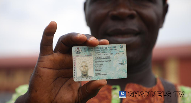 A man displays his voter's card on September 19, 2020. Photo credit: Sodiq Adelakun/Channels Television.