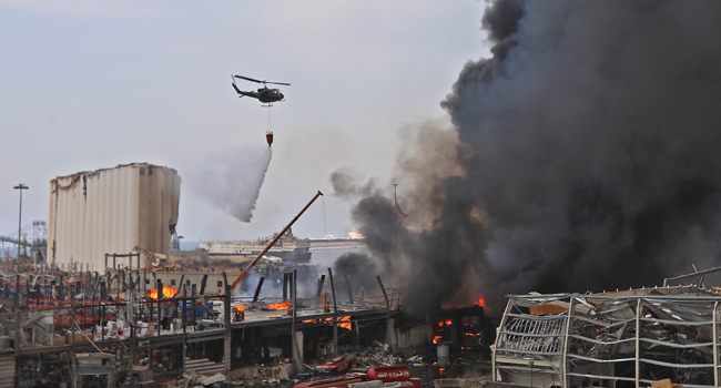 Lebanese firefighters try to put out a fire that broke out at Beirut's port area, on September 10, 2020. Thick black columns of smoke rose into the sky, as the army said it had engulfed a warehouse storing engine oil and vehicle tyres. ANWAR AMRO / AFP