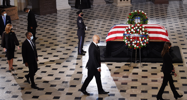 : Mourners surround the flag-draped casket of the late Associate Justice Ruth Bader Ginsburg as she lies in state inside the Statuary Hall of the U.S. Capitol September 25, 2020 in Washington, DC. Olivier Douliery-Pool/Getty Images/AFP