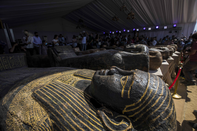 A picture taken on October 3, 2020 shows sarcophaguses, excavated by the Egyptian archaeological mission which discovered a deep burial well with more than 59 human coffins closed for more than 2,500 years, displayed during a press conference at the Saqqara necropolis, 30 kms south of the Egyptian capital Cairo.  Khaled DESOUKI / AFP