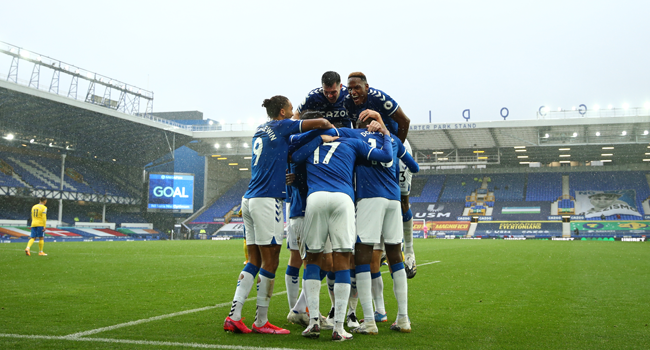 Everton's Colombian midfielder James Rodriguez celebrates with teammates after scoring their third goal during the English Premier League football match between Everton and Brighton Hove and Albion at Goodison Park in Liverpool, north west England on October 3, 2020. Jan Kruger / POOL / AFP