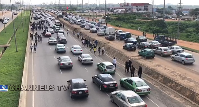 PHOTOS: #EndSARS Protesters Block Abuja Airport Road