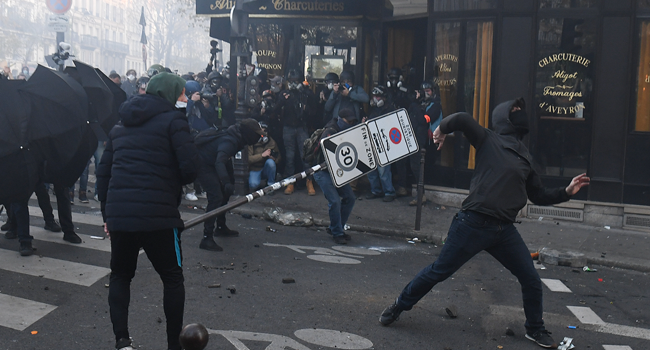 Demonstrators clashes with police during a protest against the 'global security' draft law, which Article 24 would criminalise the publication of images of on-duty police officers with the intent of harming their 'physical or psychological integrity', in Paris, on November 28, 2020. Alain JOCARD / AFP
