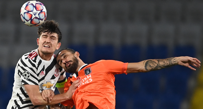 Manchester United's English defender Harry Maguire (L) fights for the ball with Istanbul Basaksehir's Turkish midfielder Mehmet Topal during the UEFA Champions League football match group H, between Istanbul Basaksehir FK and Manchester United, on November 4, 2020, at the Basaksehir Fatih Terim stadium in Istanbul. OZAN KOSE / AFP